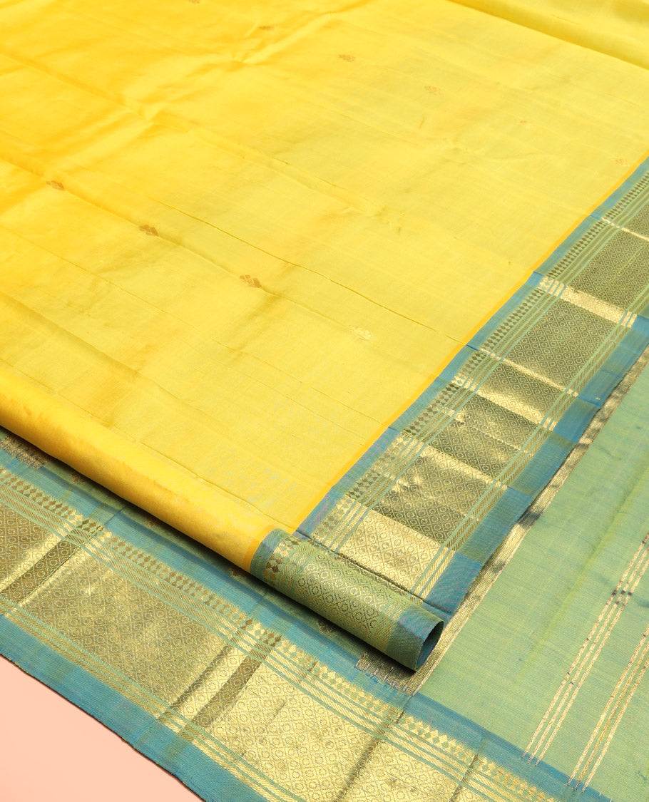 Yellow Kanchipuram Silk Saree, Subtly Sparkled with Zari Buttas, Contrast One-Sided Border of Paneer Sombu, Banaras, and Mayil Kann, Zari Design Pallu, and No Blouse