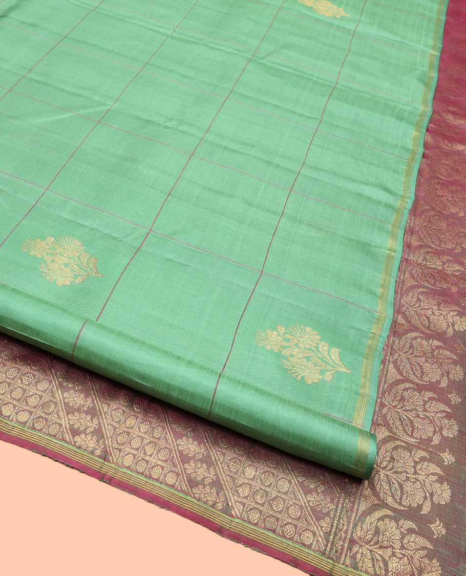 Green Kanchipuram Silk Saree, Beautifully Woven with Floral Butta Enclosed, Checked All Over Its Body, Subtle Zari Piping Border, Captivating Pallu of Intricate Designs, and Paired with a Contrast Blouse