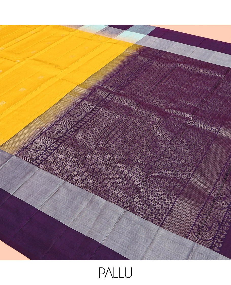 Yellow Kanchipuram Silk Saree, Sparsely Sparkled with Mayil-Chakram Buttas, Complemented by a Contrast Checked Yaanai Motif Border, Floral Pallu, and a Contrast Blouse