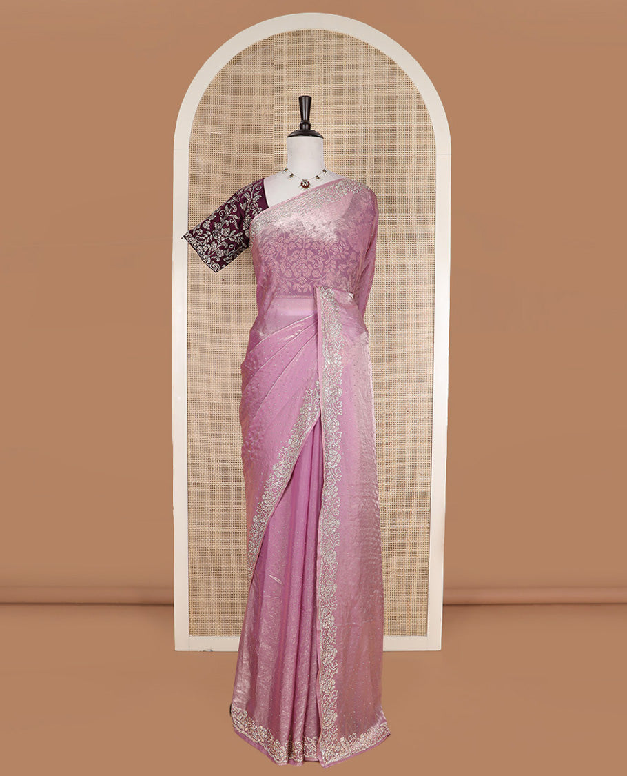 Pink stone work designer saree, micro-stone work border, and a contrast half-sleeve blouse of floral vine design in micro stones