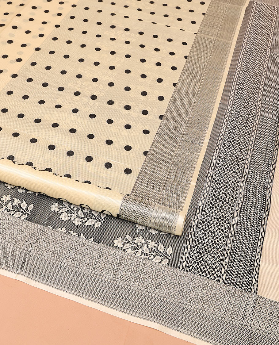 Cream Mayuri Soft Silk Saree, Accentuated with Polka Dot Buttas All Over Its Body, Sparsely Woven Geometric Patterned Border, Pallu Steeped with Floral Designs, and Paired with a Matching Blouse