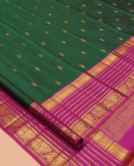 Green Kanchipuram Silk Saree, Adorned with Manga Buttas, a Contrast Korvai Border of Thilakam, Muthu, Vanki, Diamond, Kathir, and Mayil Designs, Jaal Pallu, and a Contrast Blouse
