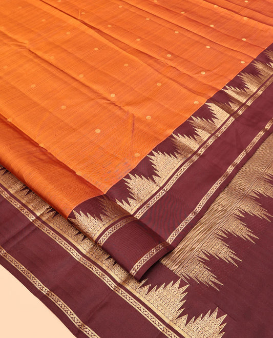 Orange Vasundhara Silk Saree, Delicately Woven with Zari Buttas, Complemented by a Contrast Rettai Pettu Border of Thazampoo Rekku Designs, Vanki Pallu, and a Contrast Blouse