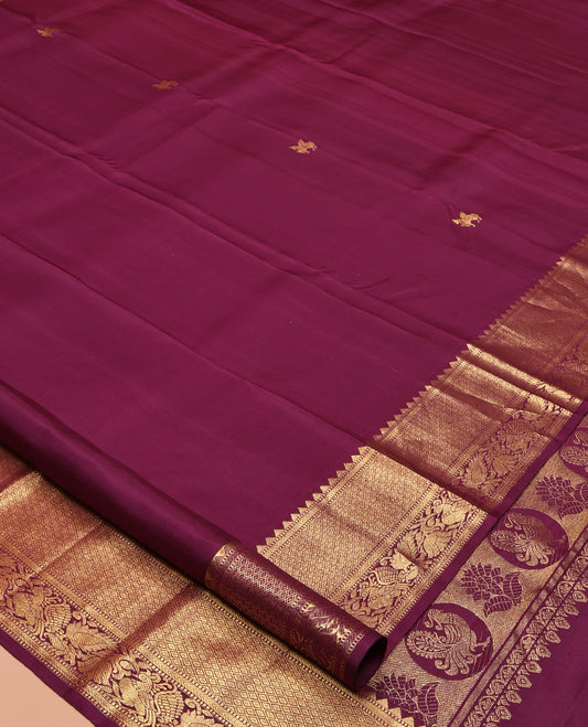 Maroon Kanchipuram Silk Saree, Accentuated with Kuthirai Buttas All Over Its Body, Highlighted by a Zari Border of Rekku, Muthu, Kathir, Mayil Kann, and Mayil Designs, Grand Jaal Pallu, and Paired with a Matching Blouse
