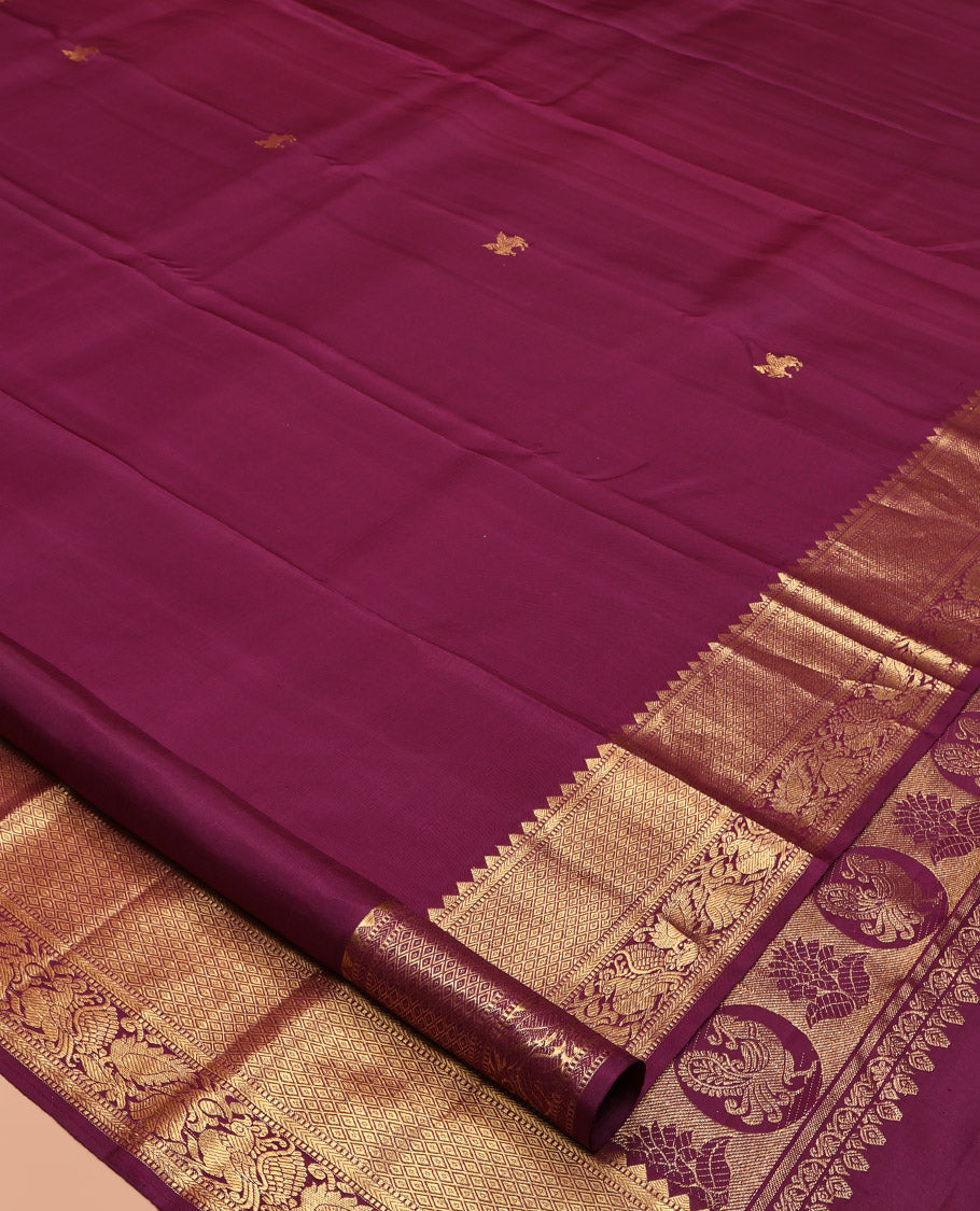 Maroon Kanchipuram Silk Saree, Accentuated with Kuthirai Buttas All Over Its Body, Highlighted by a Zari Border of Rekku, Muthu, Kathir, Mayil Kann, and Mayil Designs, Grand Jaal Pallu, and Paired with a Matching Blouse