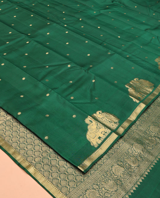 Green Vasundhara Silk Saree, Majestically Detailed with Zari Buttas and Mayil-Yaanai Buttas, a Subtle Zari Border, Jaal Pallu, and a Matching Blouse