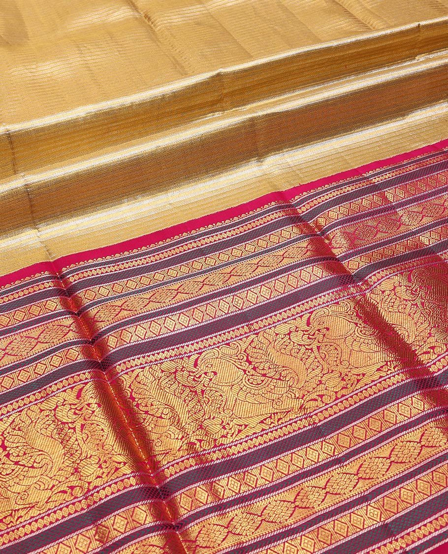 Gold striped silk half saree with contrast border of rekku, banaras, muthu, poo chakram, mayil design, zari design blouse & floral design dhavani