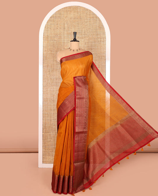 Mustard plain linen saree, contrast traditional zari design border, striped pallu, and a contrast embroidered blouse