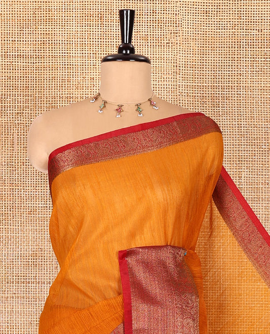 Mustard plain linen saree, contrast traditional zari design border, striped pallu, and a contrast embroidered blouse