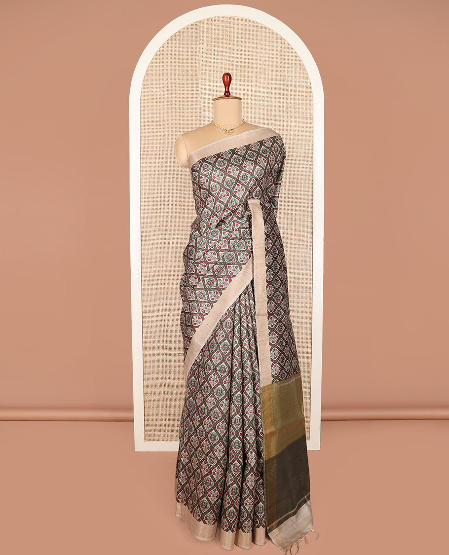Green ogee patterned tussar silk saree, contrast bavanji border, and double-color plain pallu