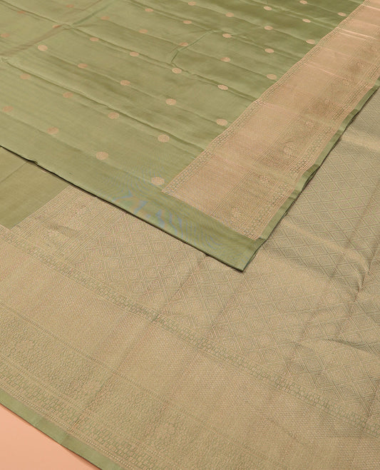 Green chakram buttas silk saree, zari border of mayil kann and floral designs, and jaal patterned pallu