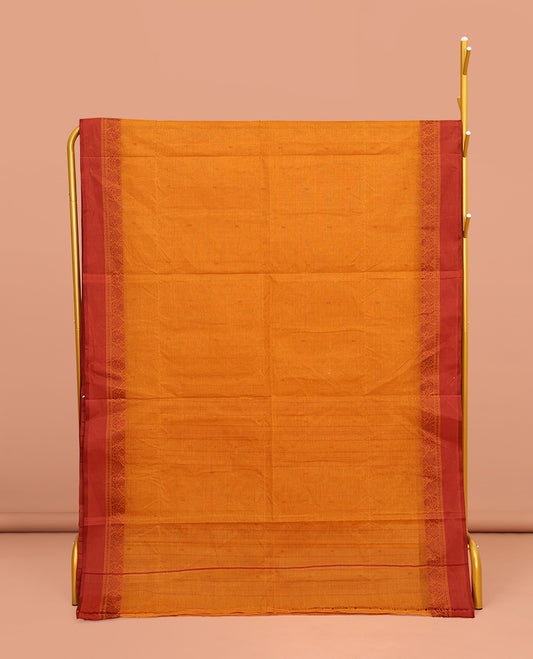 Orange Bengal Cotton Saree, Subtly Sparkled with Buttas All Over Its Body, Complemented by a Contrast Border of Unique Designs, Pallu of Stripes and Buttas, and Paired with a Matching Blouse