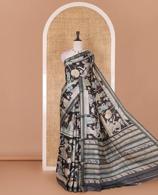 Black kalamkari ancient human figurines and animal motifs printed semi-tussar saree, gold zari piping border, printed pallu, and contrast printed blouse