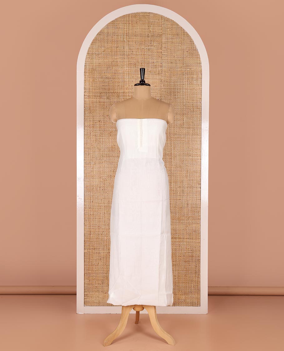 White material chudidar set, plain with pom-pom tasseled mul chanderi top, a matching bottom, and organza dupatta of stripes