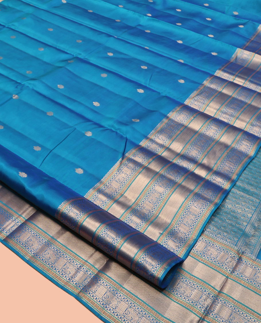 Blue Vasundhara Lite Silk Mix Saree Features Zari Buttas, a Zari Border of Kamalam, Ara Maadam, and Yaali, Pallu of Butta Enclosed Checks, and a Matching Blouse