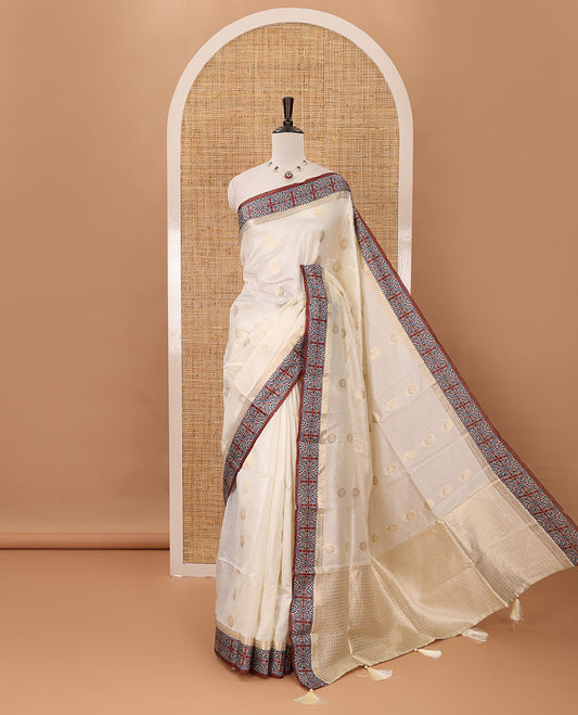 Cream gold zari buttas semi-organza saree, contrast zari & Ajrakh printed brown border, zari weaving pallu & Ajrakh printed blouse