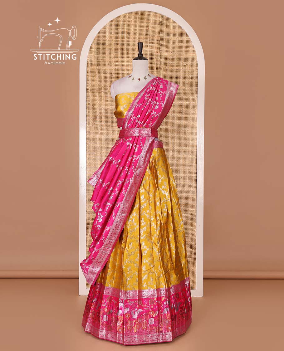 Haldi yellow taffeta silk half saree, floral jaal jacquard skirt, contrast rani zari meenakari style bird border, matching blouse, and floral jaal dhavani