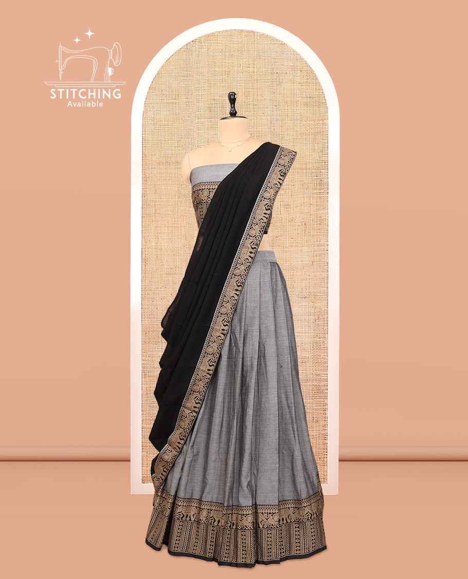 Grey Cotton Half-Saree Features Plain Skirt, a Contrast Traditional Thread Border, a Matching Blouse, and a Contrast Dhavani