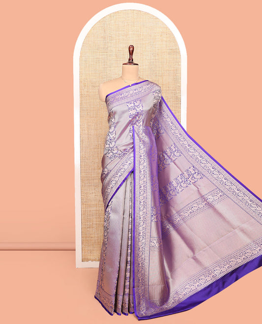 Violet Semi-Banaras Silk Saree, Gracefully Embellished with Animal-themed Jacquard Designs on Its Body, Highlighted by a Zari Border of Traditional Designs, Pallu Steeped with Stripes, and Paired with a Matching Blouse
