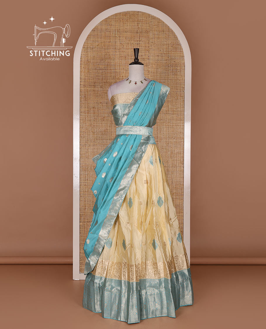 Cream taffeta silk half saree, meena buttas skirt, contrast blue traditional zari border, matching blouse, and zari woven dhavani