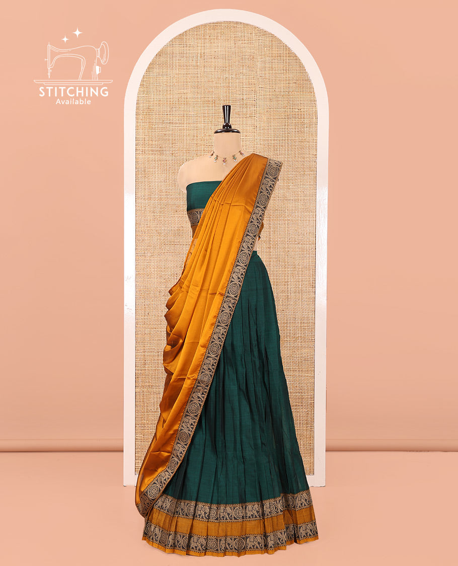 Bottle Green-Mustard Mercerised Cotton Half-Saree Features Plain with Contrast Rettai Pettu Elephant-Chakram Bordered Skirt, Paired with a Matching Blouse, and Comes with a Contrast Elephant-Chakram-Bordered Dhavani