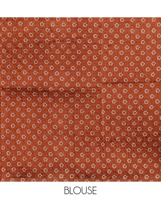 Rust batik-printed square motifs Litchi crushed saree, batik-printed border & pallu of geometric & floral batik print