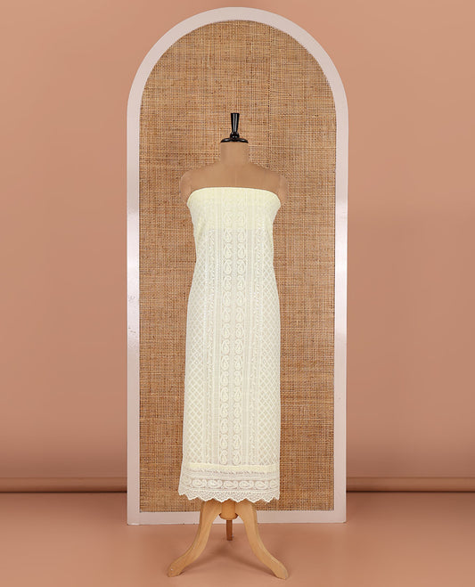 Lemon yellow material chudidar set, paisleys and jaal schiffli sequins embroidered mul georgette top, a matching bottom, and a mirror work dupatta