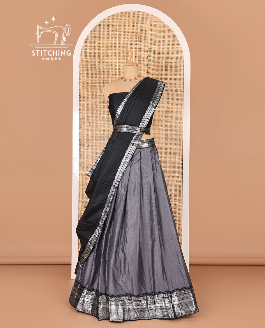 Grey taffeta silk half-saree, plain with a contrast traditional design bordered skirt, contrast blouse, and traditional zari bordered blouse
