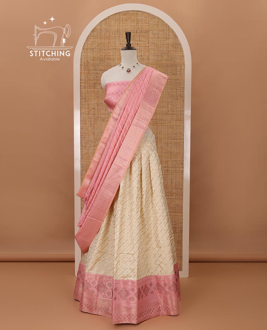 Cream semi-banaras half saree,leheriya zari skirt,contrast onion pink zari & swarovski stonework border,jacquard blouse & zari weave dhavani