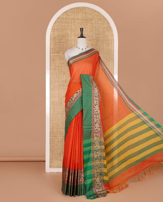 Orange plain mercerised cotton saree, contrast traditional border of peacock, and elephant motifs, striped pallu, and a matching blouse