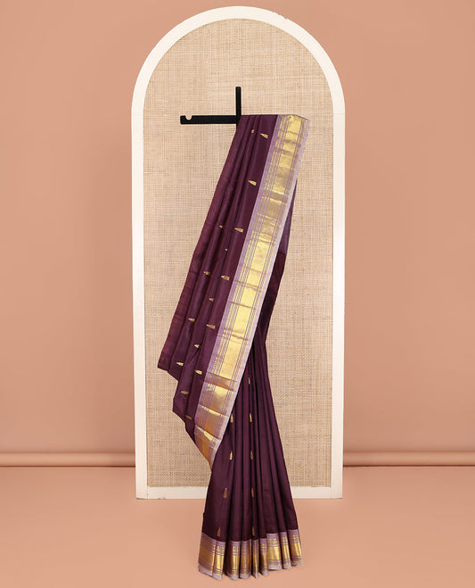 Brown Kanchipuram Silk Saree, Ornamented with Thazampoo Rekku Zari Buttas on Its Body, Complemented by Contrast One-Sided Border of Panner Sombu, Banaras, Muthu, and Mayil Kann Designs, Pallu Features Zari Designs, and Comes Without a Blouse