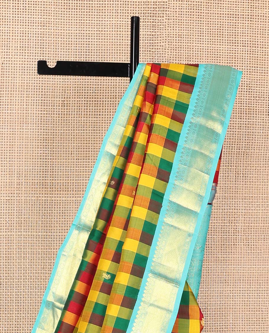 Multi-color paalum pazhamum checks, and buttas Kanchipuram korvai silk saree, contrast korvai border of thilakam mokku, muthu, and laddu kamalam, and annam chakram enclosed pallu