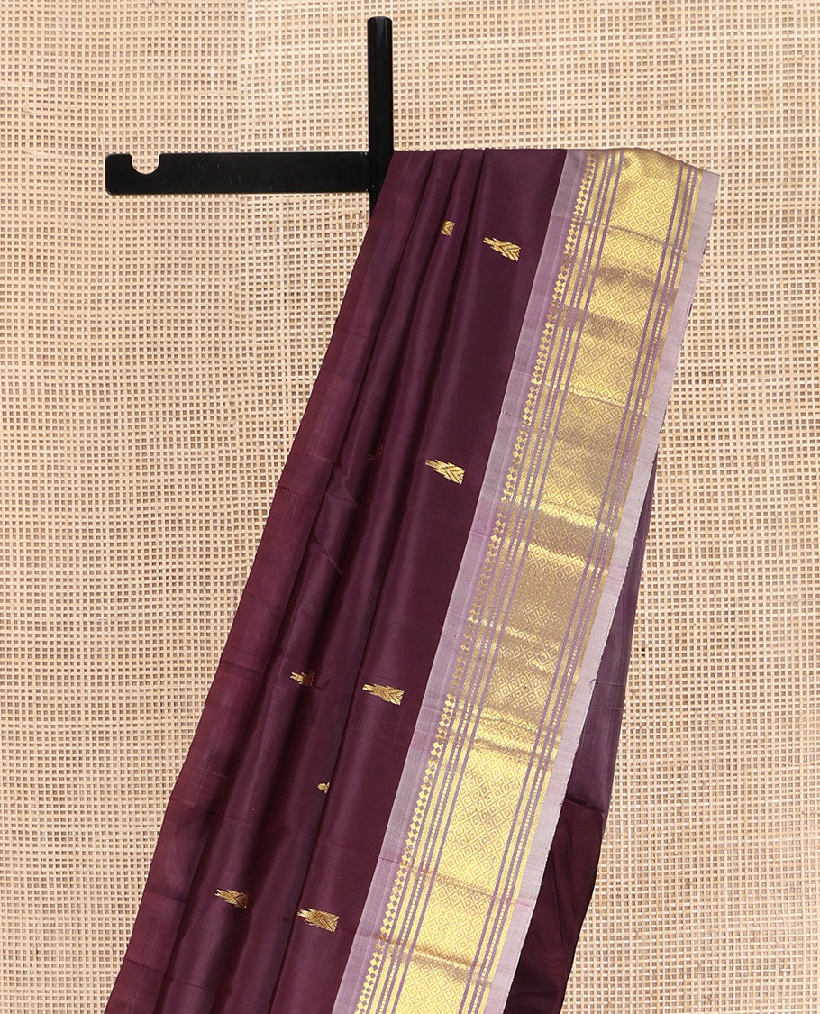 Brown Kanchipuram Silk Saree, Ornamented with Thazampoo Rekku Zari Buttas on Its Body, Complemented by Contrast One-Sided Border of Panner Sombu, Banaras, Muthu, and Mayil Kann Designs, Pallu Features Zari Designs, and Comes Without a Blouse