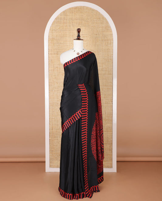 Black turkey crepe saree with printed temple border & circle pallu along with butta design blouse