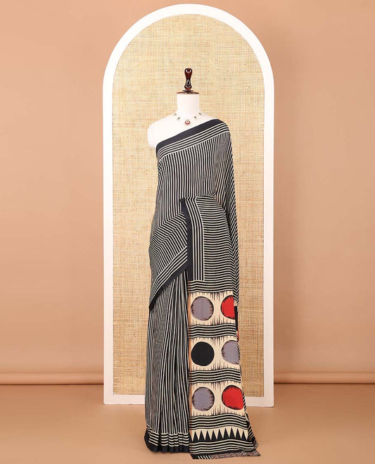 Black vertical stripes printed modal satin saree, a self-border of horizontal stripes print, polka dots printed on the pallu, and an intricate ajrakh-style printed blouse