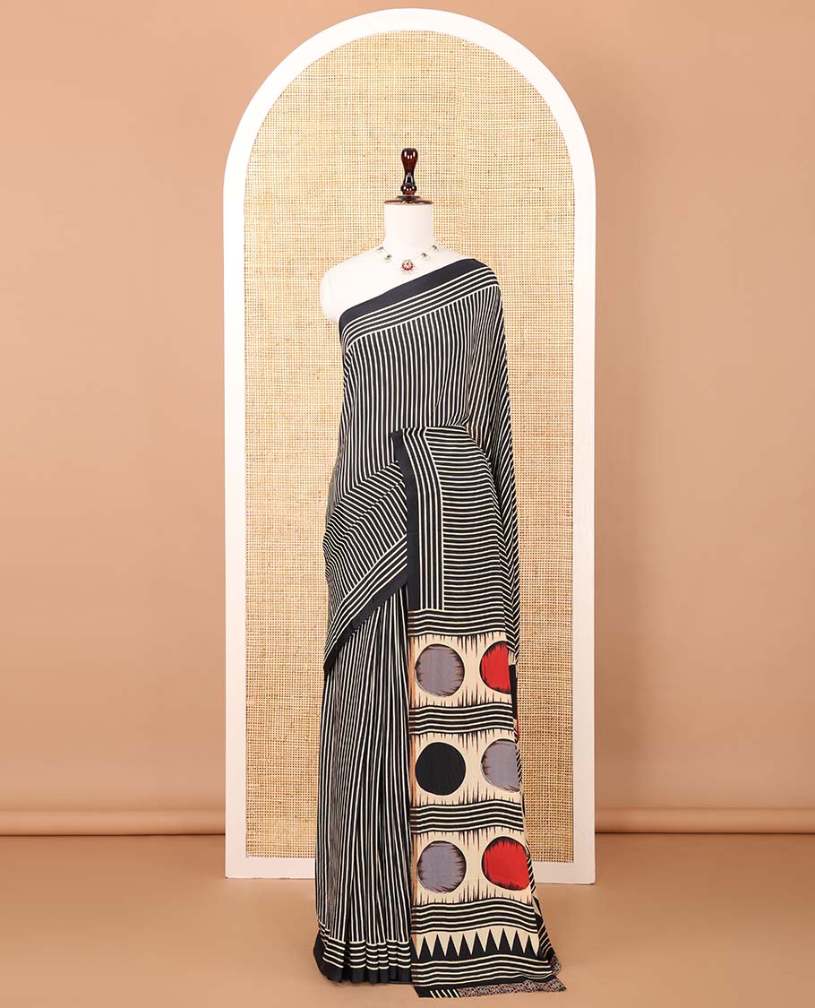 Black vertical stripes printed modal satin saree, a self-border of horizontal stripes print, polka dots printed on the pallu, and an intricate ajrakh-style printed blouse