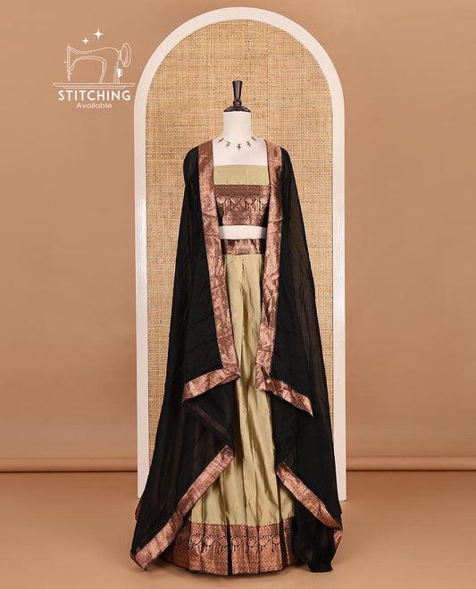 Brown taffeta silk half saree, zari buttas with contrast black traditional zari border skirt, matching zari design blouse, and contrast plain zari border syska georgette dhavani