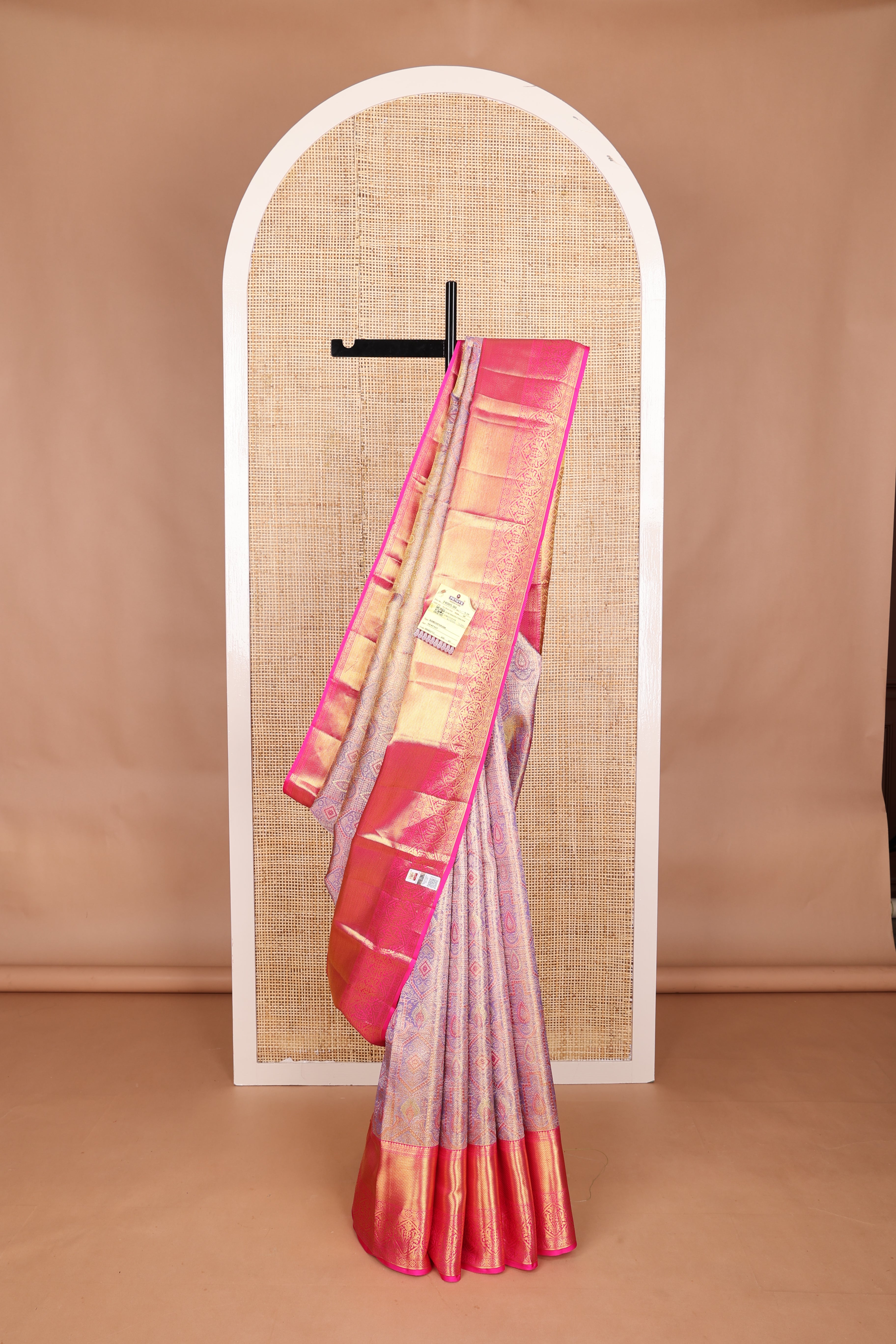 Gleaming lavender zari jacquard Kanchipuram tissue silk saree, contrast border of thilakam, kathir, muthu, kaddu kamalam, and Mughal-style floral bouquets, and jaal pallu