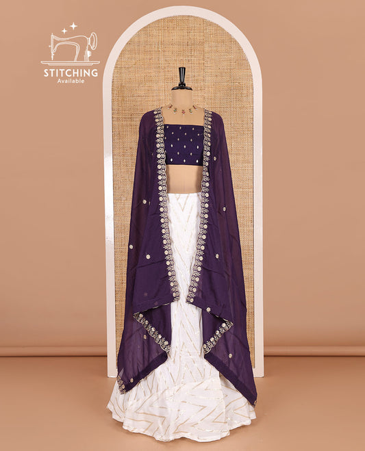 Cream-purple half-saree, gold chevron striped nylon viscose crepe skirt, contrast diamond buttas blouse, and  a contrast scallop floral-theme embroidered dhavani