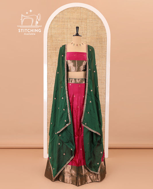 Rani pink taffeta silk half-saree, zari buttas with contrast traditional zari bordered skirt, matching zari design blouse, and contrast scallop buttas embroidered dhavani