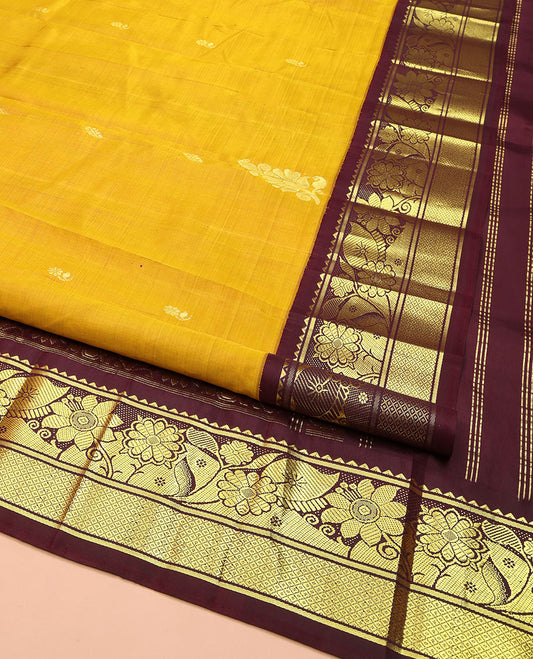 Mustard Kanchipuram Silk Saree, Decorated with Zari Buttas, Complemented by Contrast One-Sided Korvai Border of Rekku, Banaras, Floral and Mayil Kann Designs, Pallu of Floral-Paisley Designs, and Comes Without a Blouse
