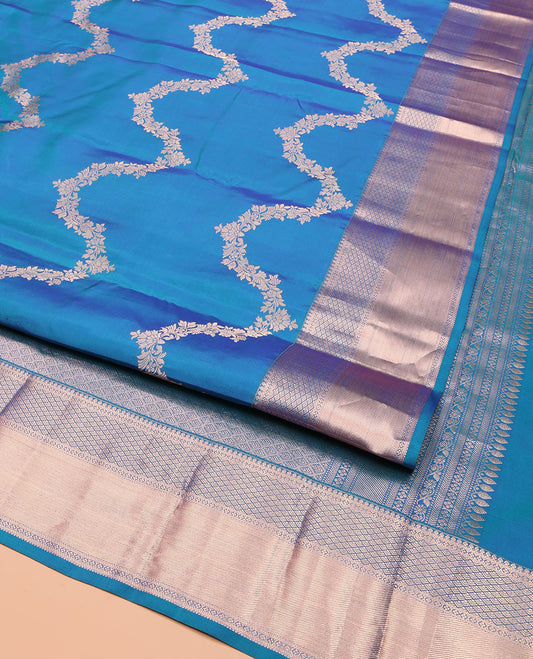 Blue Vasundhara Silk Saree, Delicately Woven with Jaal Jacquard Design All Over Its Body, Highlighted by a Zari Border of Thilakam Mokku, Jaal, and Lavangam Designs, Grand Jaal Pallu, and Paired with a Matching Blouse