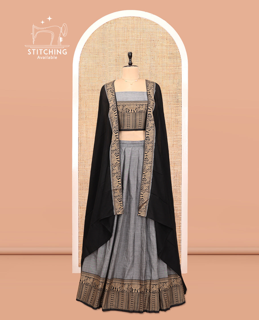 Grey Cotton Half-Saree Features Plain Skirt, a Contrast Traditional Thread Border, a Matching Blouse, and a Contrast Dhavani