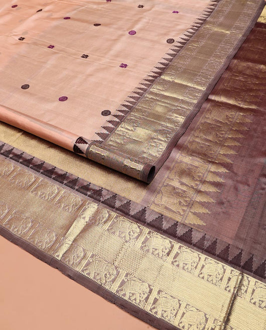 Peach Venkatagiri Silk Saree, Subtly Sparkled with Peacock and Chakram Buttas All Over Its Body, Complemented by a Contrast Temple Border of Elephant and Geometric Designs, Pallu of Geometric Designs, and Paired with a Contrast Blouse