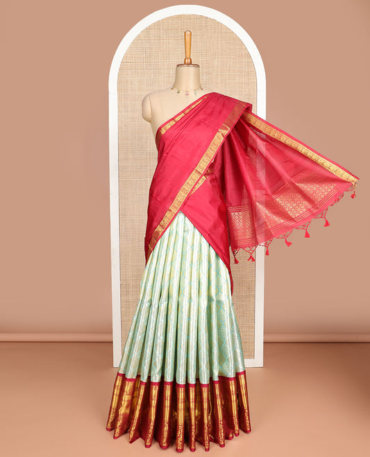 Light green floral design silk half saree with contrast thilakam mokku, kuyil kann, rekku design border, zari design blouse & zari design border dhavani