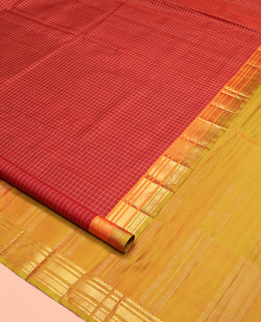 Red checked Kanchipuram silk saree, contrast border of salngai, kathir, mayil kann, and rudraksham designs, and zari striped pallu