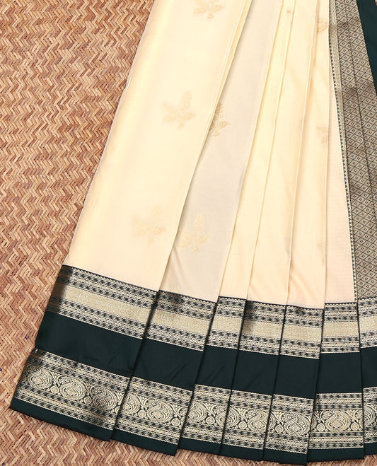Cream Budget Silk Saree, Finely Crafted with Zari Buttas All Over Its Body, Complemented by a Contrast Traditional Zari Design Rettai Pettu Border, Grand Jaal Pallu, and Paired with a Contrast Blouse