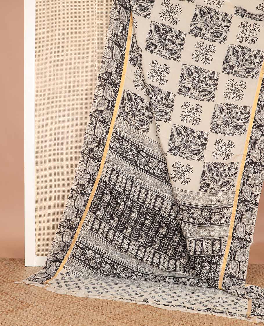 Cream floral buttas machine-printed Kalamkari cotton saree, contrast floral vine printed border, and pallu of paisley designs