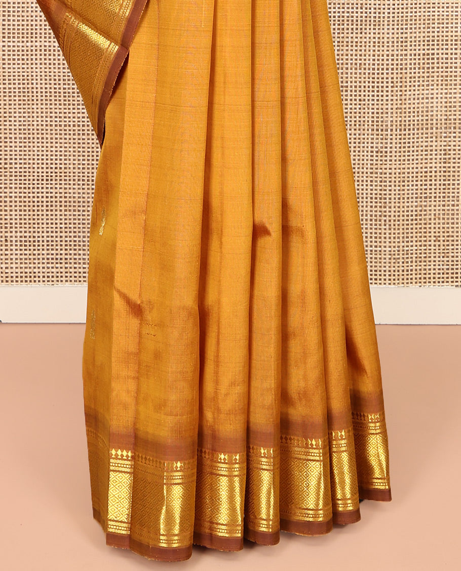 Mustard Kanchipuram Silk Saree, Adorned with Zari Buttas, a Contrast One-Sided Border of Panner Sombu, Banaras, Muthu, and Mayil Kann Designs, Zari Design Pallu, and No Blouse