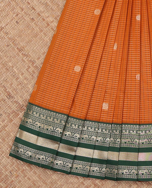 Orange Litchi Saree, Highlighted with Peacock-Chakram Buttas and Checks, a Contrast Traditional Zari Border, Intricate Pallu, and a Contrast Blouse